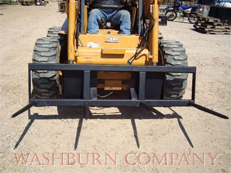 show skid steer with large bale of hay|skid steer hay spear attachment.